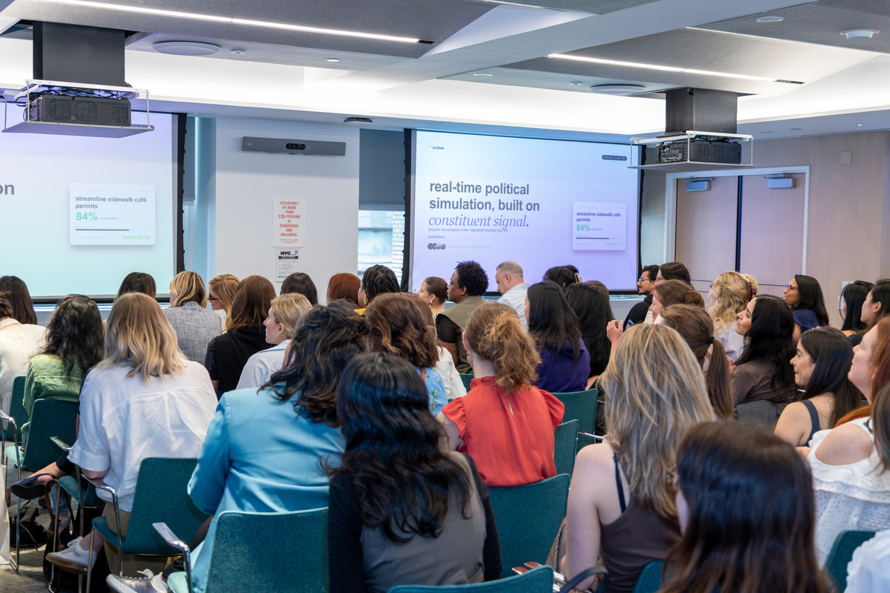 Attendees networking at a Women in AI event